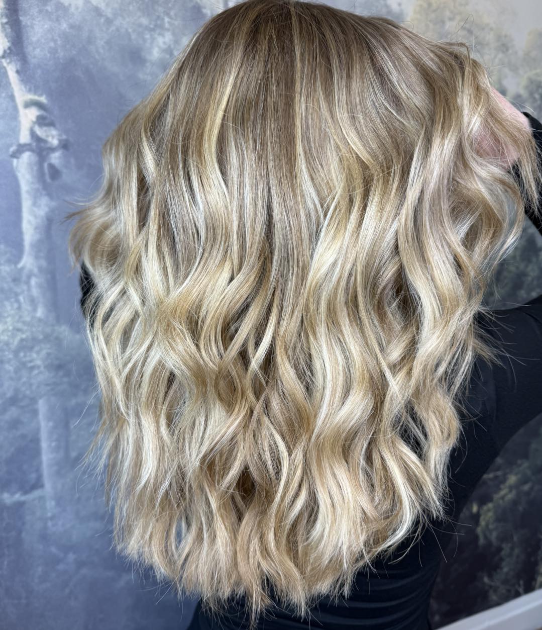 Soft blonde balayage with textured waves