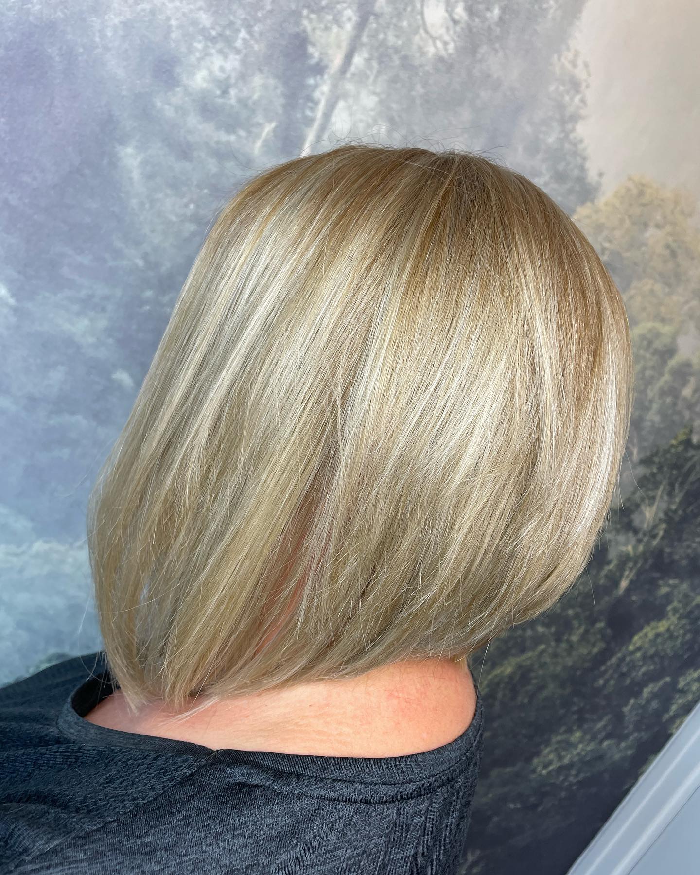 Sleek blonde bob with a precision cut and soft dimension