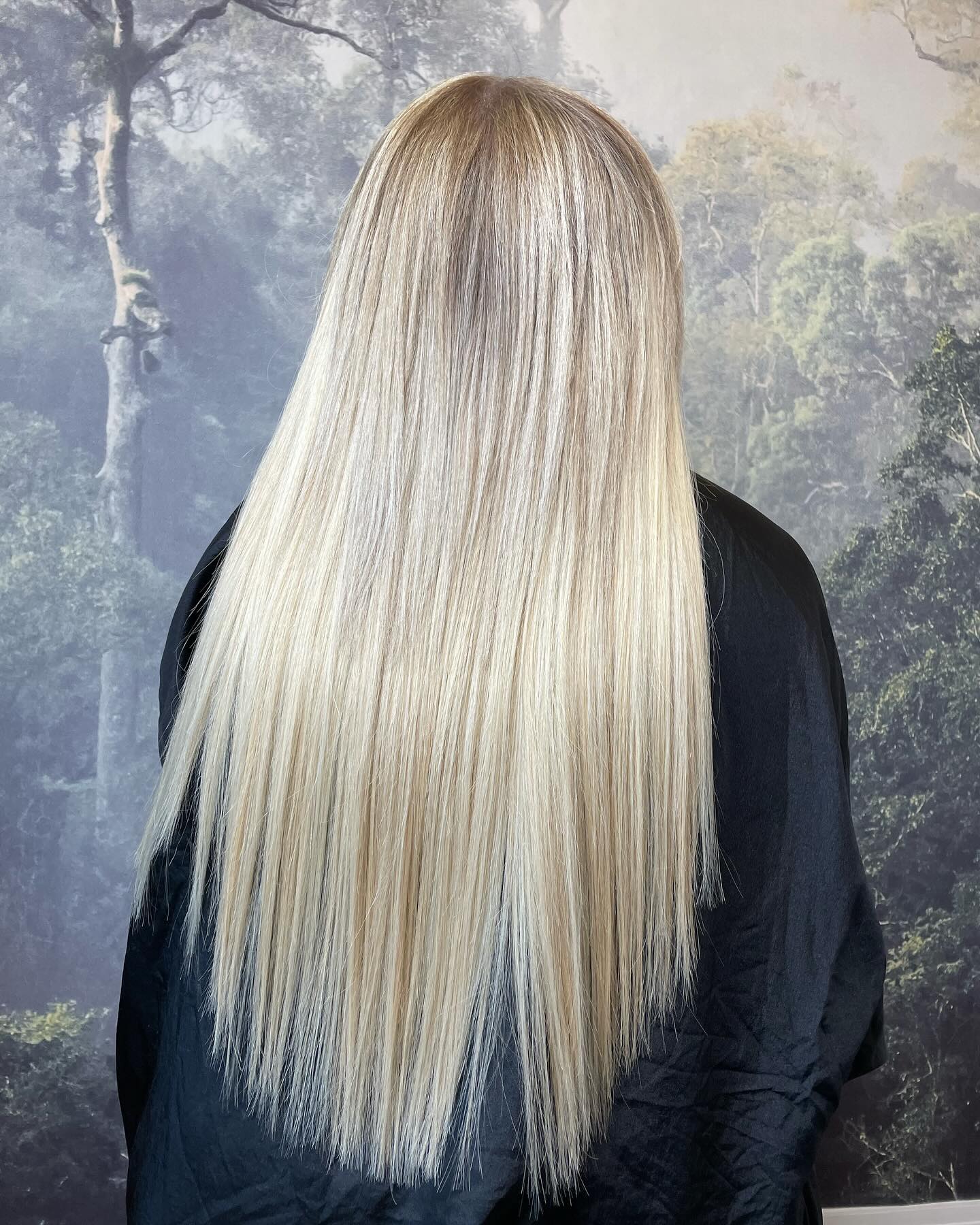 Bright platinum blonde hair with a sleek finish and high shine